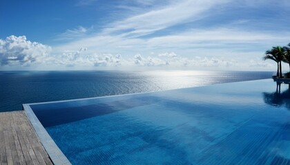 Fototapeta premium A luxury hotel infinity pool with the ocean at its edge