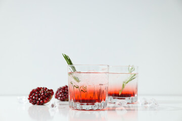 Cocktail with fresh pomegranate on a white background