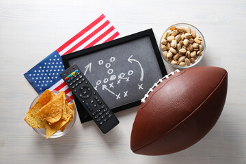 Blackboard with game strategy and rugby ball