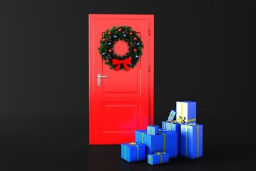 Obraz premium Festive Christmas wreath made of fir branches on a red door. There are gift packages by the door. Festive atmosphere.