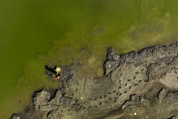 A fisherman fishing in the lake