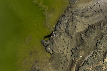 A fisherman fishing in the lake