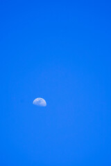 A moon in the blue sky