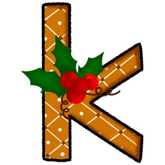Letter k christmas cookie and snow pattern and decorated with holly
