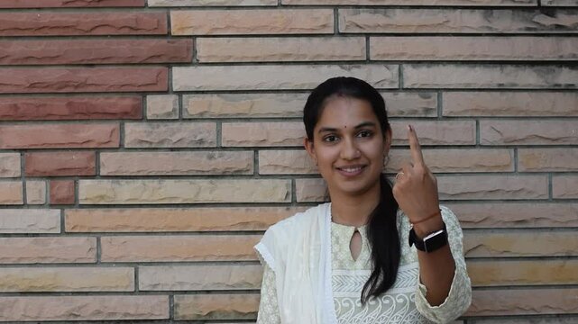 Video of an Indian woman showing her finger after casting vote in election. Lok sabha, vidhan sabha, polls, election commission of india, technology, democarcy, voice, choice, rajasthan, maharashtra
