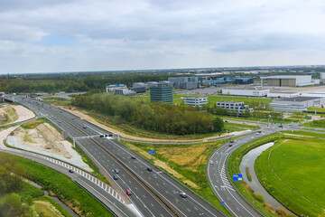 Naklejka premium An aerial view of Amsterdam, Netherlands, showing rooftops in cloudy weather