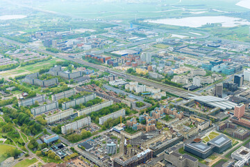 Obraz premium An aerial view of city Amsterdam, Netherlands, showing over rooftops of neighborhood cloudy weather
