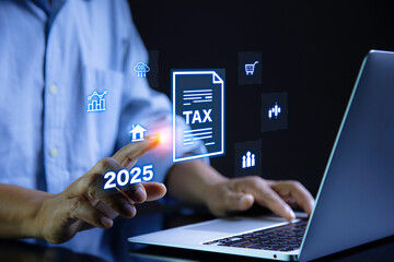 paying taxes online . man using laptop analysis tax data on futuristic virtual screen. income tax system icon around. pay online tax. futuristic virtual screen interface technology.Money save idea.