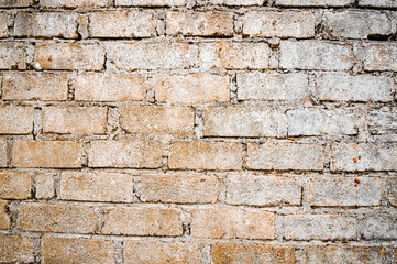 Brown white house brick wall surface texture background weathered bricks, cement joints, and old aged, grungy appearance. Ideal for urban, vintage design. Focus on wall, noisy, similar others