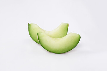 Green cantaloupe melon with cut slice isolated on white background, green melon