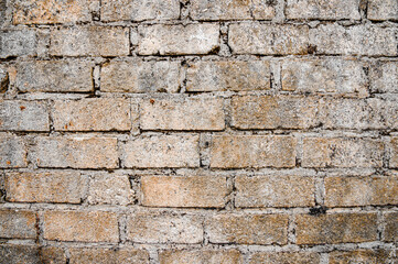 Brown white house brick wall surface texture background weathered bricks, cement joints, and old aged, grungy appearance. Ideal for urban, vintage design. Focus on wall, noisy, similar others