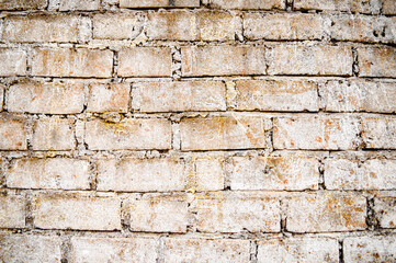 Brown white house brick wall surface texture background weathered bricks, cement joints, and old aged, grungy appearance. Ideal for urban, vintage design. Focus on wall, noisy, similar others