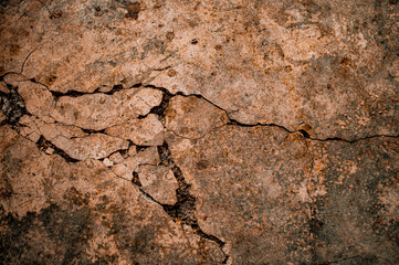 Cracked Brown wall texture. Dirty Grunge Stone background. Sandy Rough structure. Abstract texture. Rock surface with cracks. Urban design. Focus on wall. noisy, similar others
