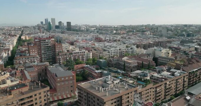 Beautiful slow motion zoom in shot in general shot of the buildings of Madrid city during the day in the area of Barrio del Pilar.