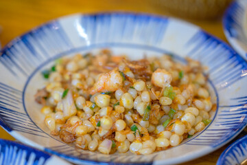 Vietnam street food. Bap Xao or Conr with oil and small shrimp. Fried corn ( bap xao ) vietnamese street food in Ho Chi Minh city, Vietnam.