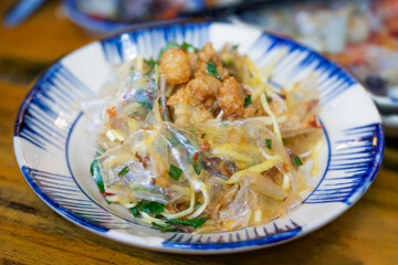 Rice paper mixed with shrimp salt. Vietnamese street food . Banh Trang Tron Mixed Rice Paper with Quail Eggs chili oil boil egged peanut roasted garlic green mango stripe shrimp salt. 