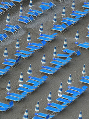 Beach chairs in a row on the beautiful Positano beach creates a repetitive pattern. On a peaceful quiet summers morning