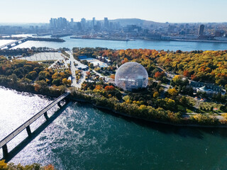 Drone view of autumn Park Jean-Drapeau, biosphere, with the downtown of Montreal in the background....