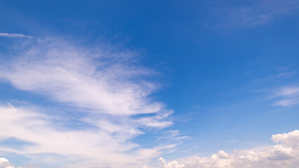 Obraz premium clear blue sky background,clouds with background, Blue sky background with tiny clouds. White fluffy clouds in the blue sky. Captivating stock photo featuring the mesmerizing beauty of the sky and cl