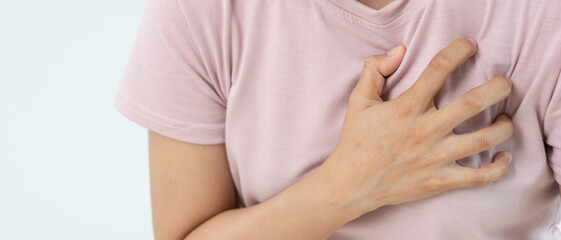 hand hold chest with heart attack symptoms, asian woman have chest pain caused by heart disease, leak, dilatation, enlarged coronary heart, press on the chest with a painful expression.