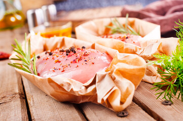 Fresh chicken breast fillet on a wooden table