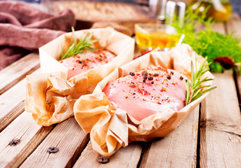 Fresh chicken breast fillet on a wooden table