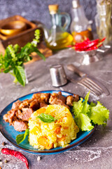 boiled rice with fried meat on plate