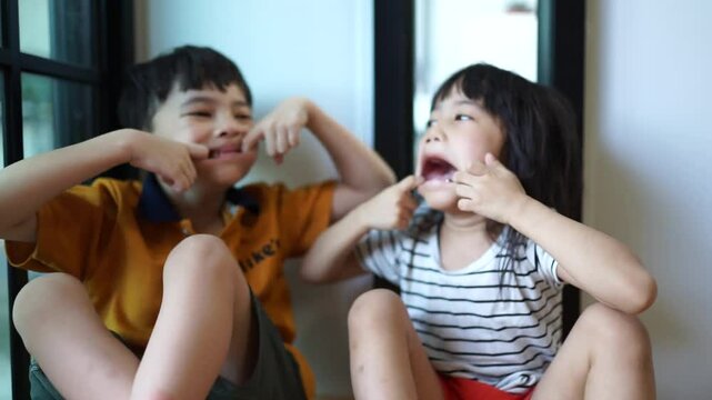 Family, children and sister and brother relax on a sofa, happy and laughing in their home together. Portrait, kids and siblings bond in a living room,