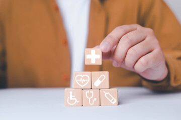 Insurance and safety protection concept of businessman. Businessman placing wooden blocks with icons displayed with a white background. healthcare, insurance, investment