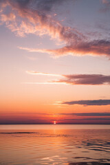 Fototapeta premium breathtaking sky at sunset or sunrise, with light clouds drifting across and the real sun casting a warm glow