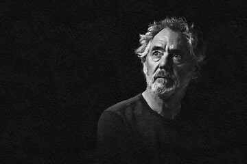 Black and white portrait of an attractive older Caucasian man with grey hair and beard. Turned to the right side, looking upward, with a serious or pensive expression.
