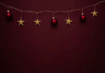 Elegant Christmas ornaments and stars hanging on a string against a deep red background. A festive image of alternating red Christmas baubles and gold glitter stars hanging 