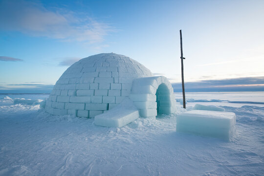 A traditional igloo made of ice blocks, located in the Arctic region