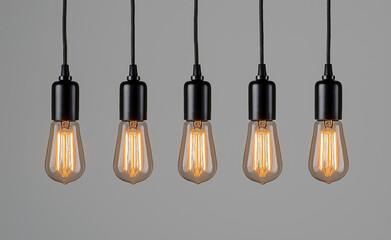 Row of vintage-style Edison light bulbs with warm glow hanging from the ceiling.