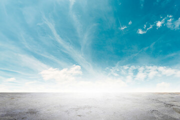 Wide empty grunge cement counter table top on blue sky clouds white light background for business product windy scene, blue sky empty land back a concrete road way