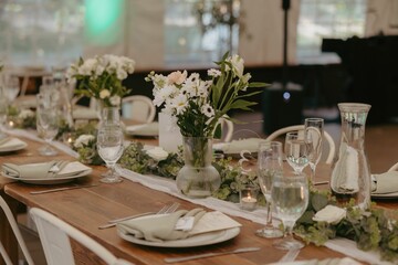 Elegant wedding table setting with flowers and glasses, perfect for a romantic celebration
