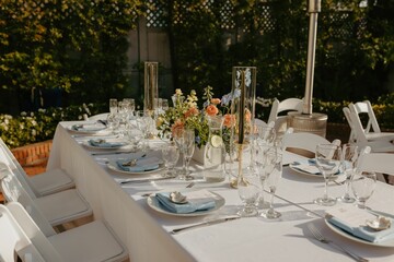 Elegant wedding table setting with flowers and glasses, perfect for a romantic celebration