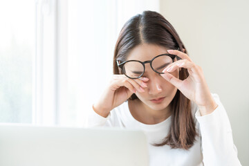 Eye problem concept, fatigue asian young woman tired eyes, irritated rubbing eye dry relief vision pain after work on laptop computer, eye strain, while wearing glasses, suffer migraine, bad blurry.