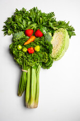 Fresh vegetables arranged in a funny face shape promoting healthy eating