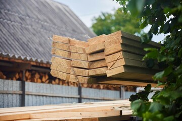 Unloading of wood. Sawn boards. Building material in the industry