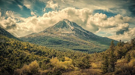 Majestic mountain landscape under a cloudy sky in a serene forest during the afternoon