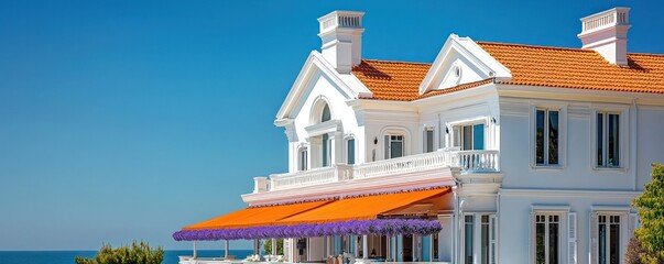 Lavender awning on a white seaside residence with orange roof, clear sky.