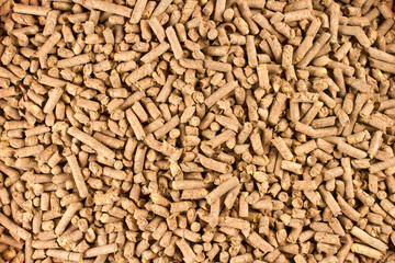 Cat litter granules. The texture of pressed sawdust granules is the top view.