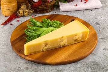 Hard parmesan cheese triangle over board