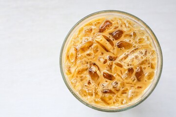 Iced coffee on white background, top view 