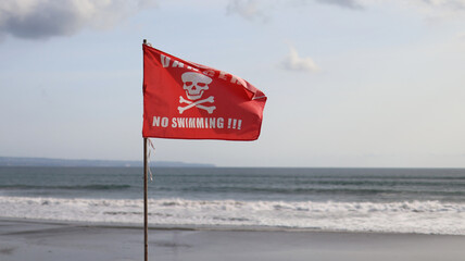 Danger No Swimming warning sign Red Flag on the Indian Ocean Beach 