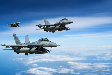 Three combat fighter jet on a military mission with weapons - rockets, bombs, weapons on wings...