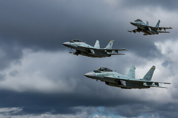 Three combat fighter jet on a military mission with weapons - rockets, bombs, weapons on wings...