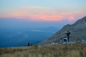 team of hikers taking rest while whatching sunrise