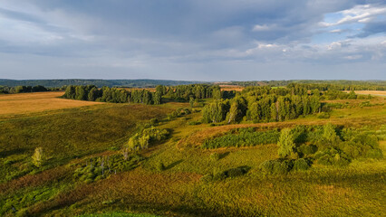 dawn over a green hilly meadow